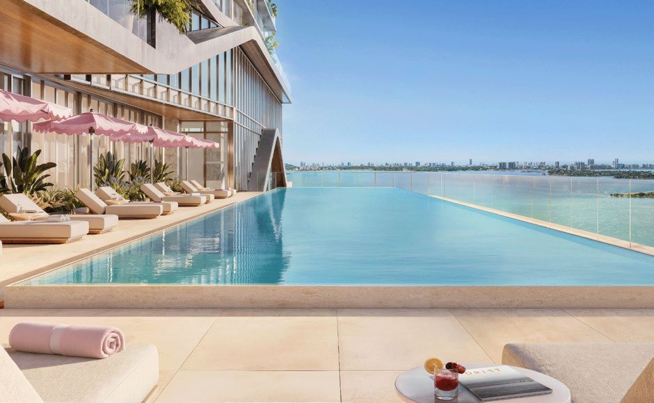 Resort-style infinity pool deck with private cabanas overlooking Biscayne Bay, from the approved project materials.